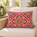 Pink Moroccan medallion outdoor lumbar pillow styled on patio furniture