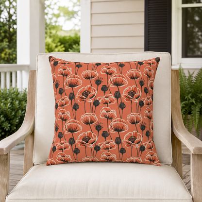 Coral poppies and black seed heads on terracotta outdoor pillow