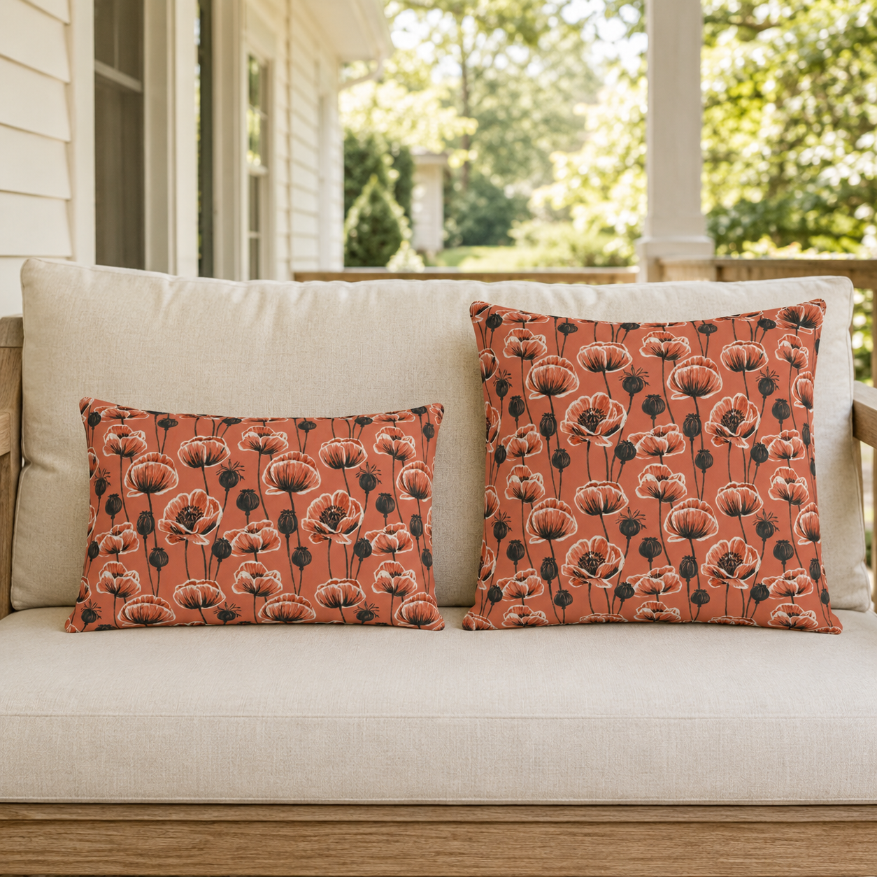 Coral poppies and black seed heads on terracotta outdoor pillow