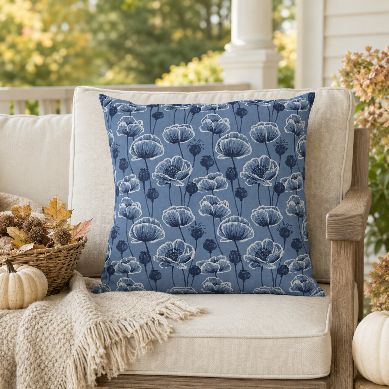 Navy and white poppies and seed heads on blue outdoor pillow