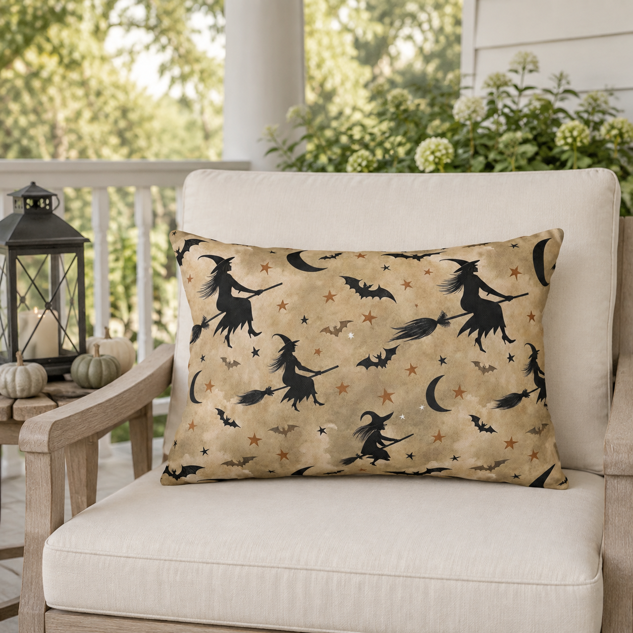 Black witch silhouettes on broomsticks with bats and crescent moons on tan outdoor lumbar pillow