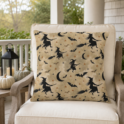 Black witch silhouettes on broomsticks with bats and crescent moons on tan outdoor pillow