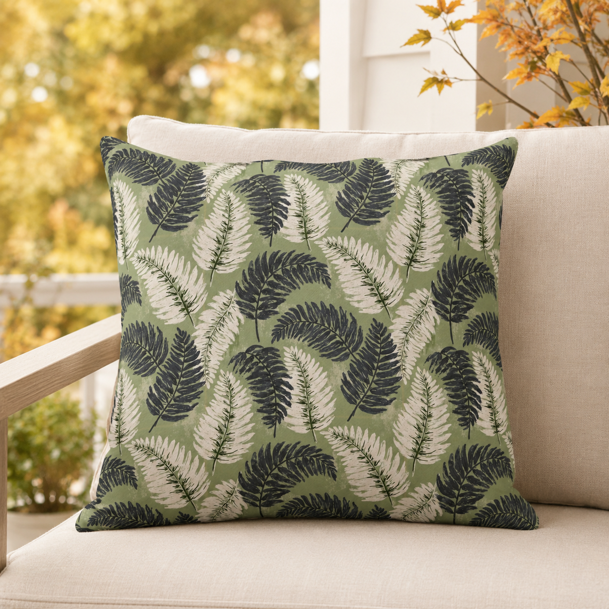 Navy and cream fern fronds on sage green outdoor pillow