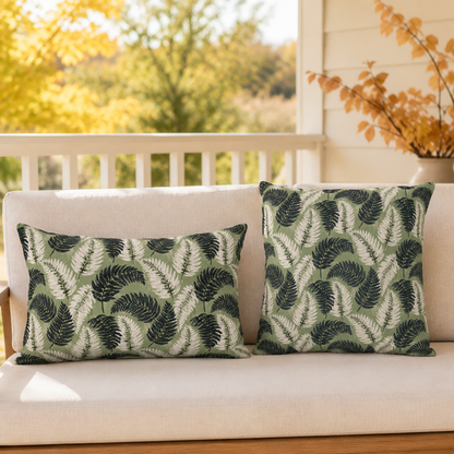 Navy and cream fern fronds on sage green outdoor lumbar pillow