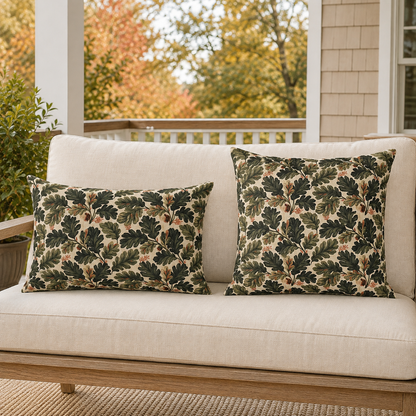 Deep green oak leaves and acorns on cream outdoor pillow
