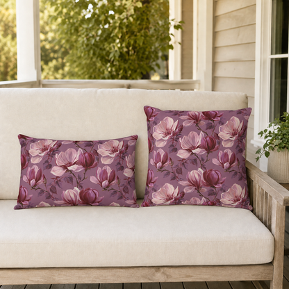 Blush and burgundy painted magnolias on mauve outdoor pillow