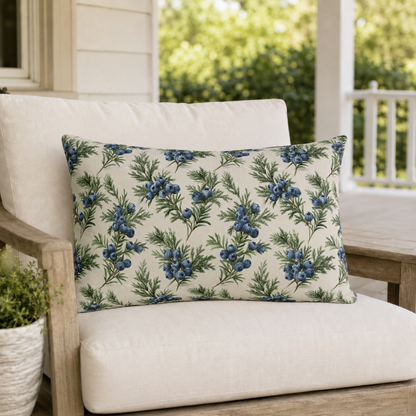 Blue juniper berries and green foliage on cream outdoor lumbar pillow