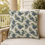 Blue juniper berries and green foliage on cream outdoor pillow