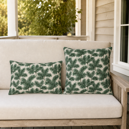 Deep green pine and fir branches on cream outdoor pillow