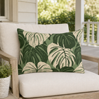 Cream and forest green monstera leaves on sage outdoor lumbar pillow