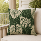 Cream and forest green monstera leaves on sage outdoor pillow