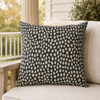 Hand-painted cream dots on charcoal outdoor pillow