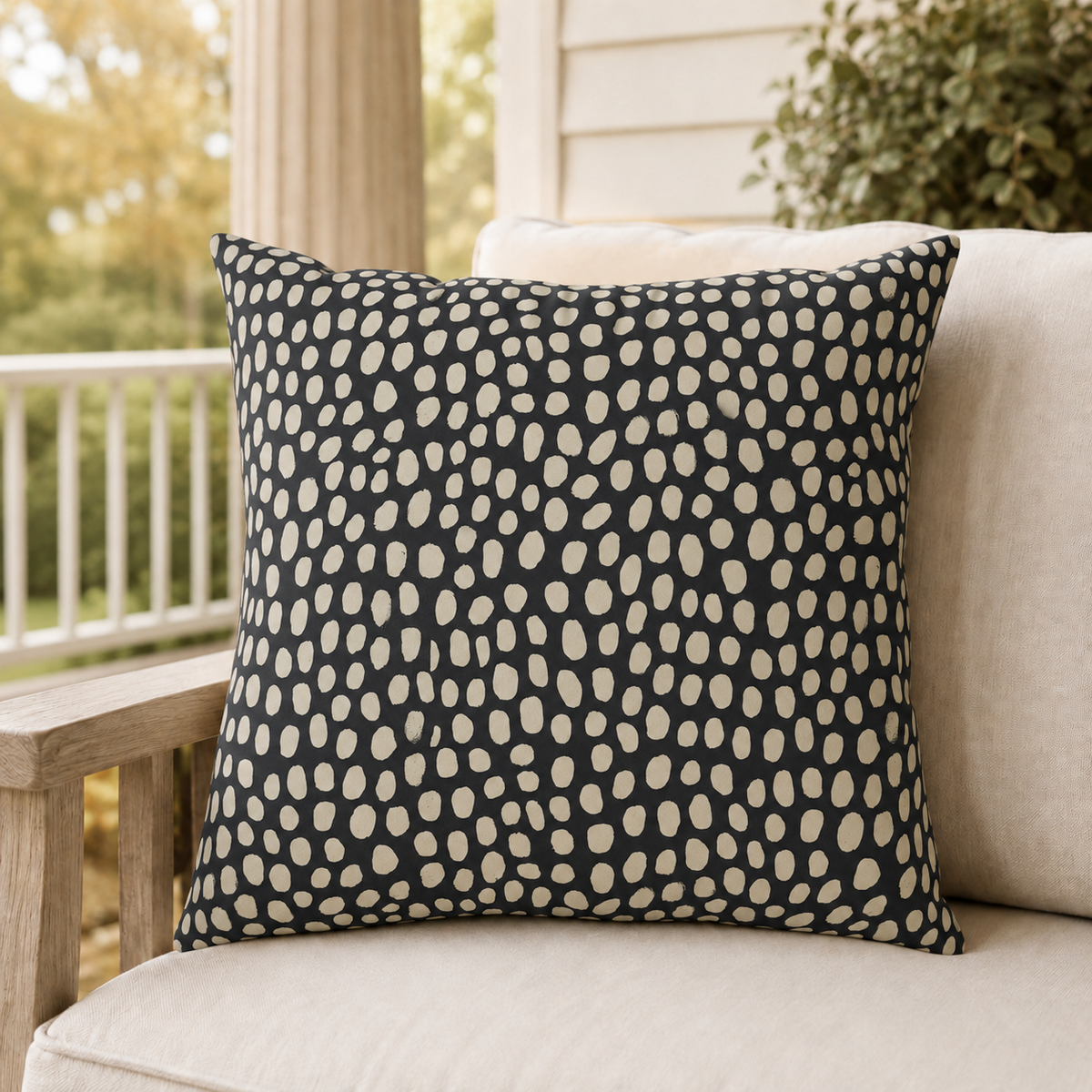 Hand-painted cream dots on charcoal outdoor pillow
