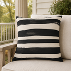 Cream outdoor pillow with wide black painted stripes, second view