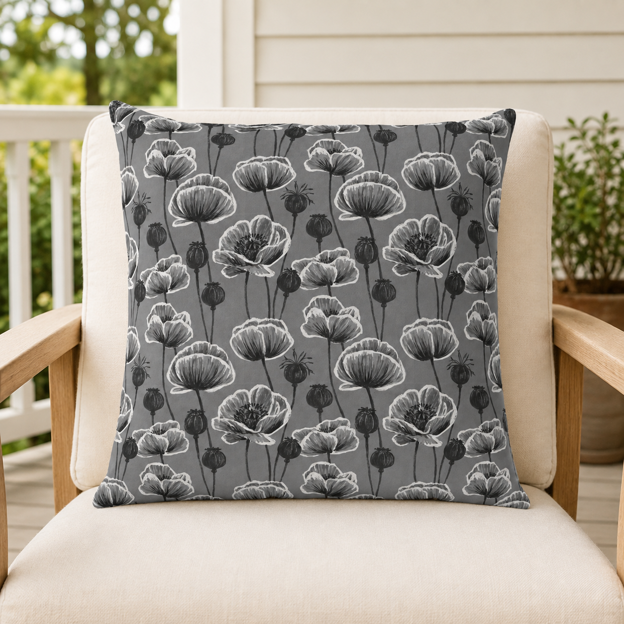 White and charcoal poppies and seed heads on grey outdoor pillow