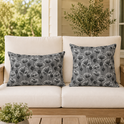 White and charcoal poppies and seed heads on grey outdoor pillow
