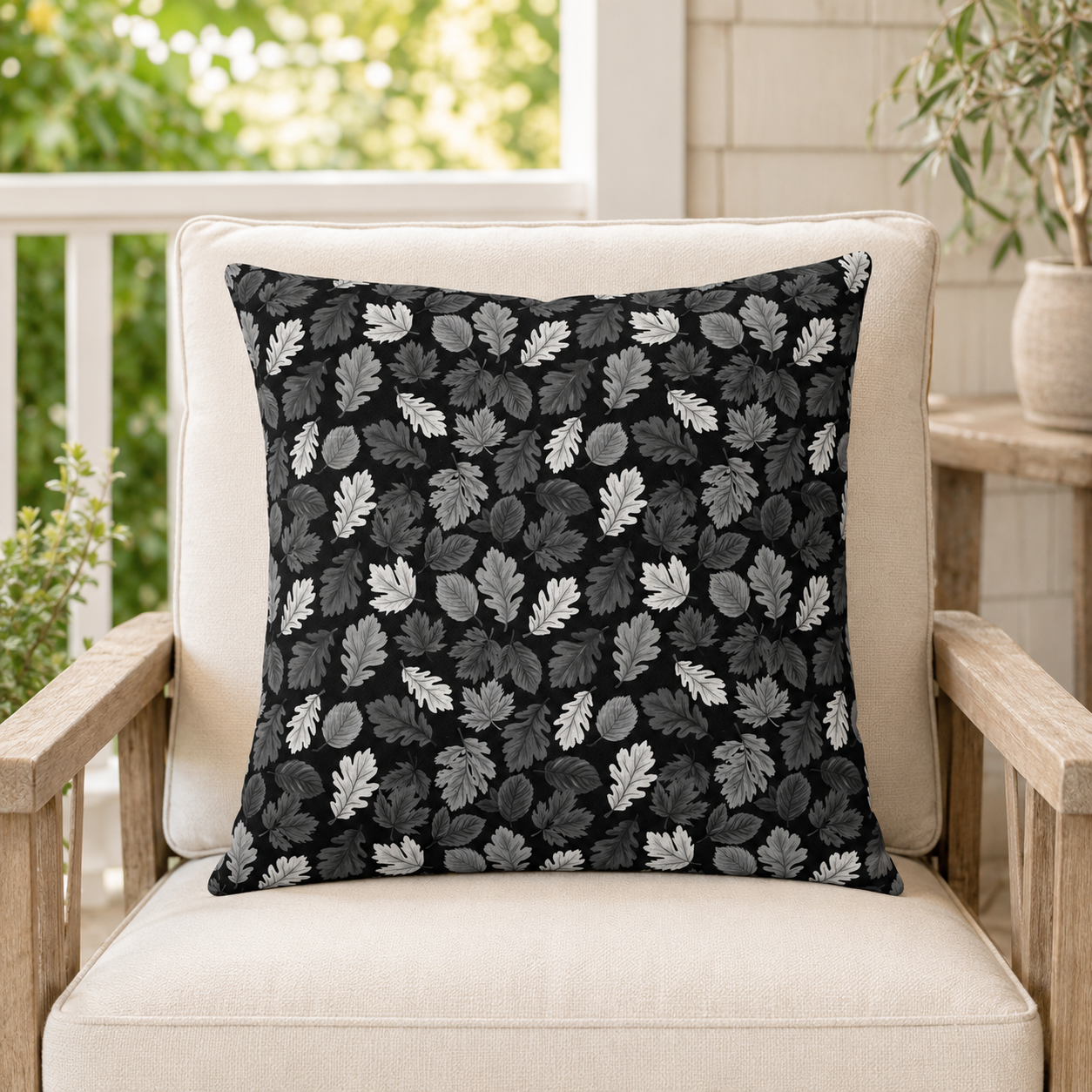 Charcoal, grey and white autumn leaves on black outdoor pillow