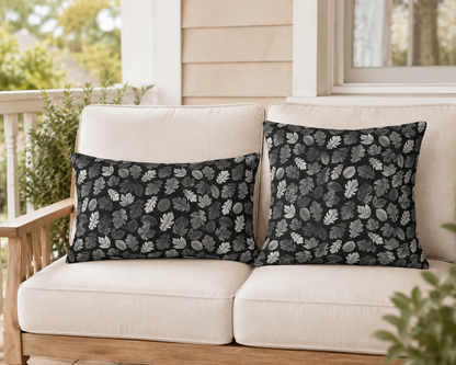 Charcoal, grey and white autumn leaves on black outdoor pillow