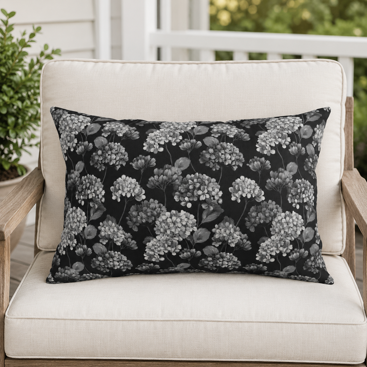 White and grey hydrangeas on black outdoor lumbar pillow