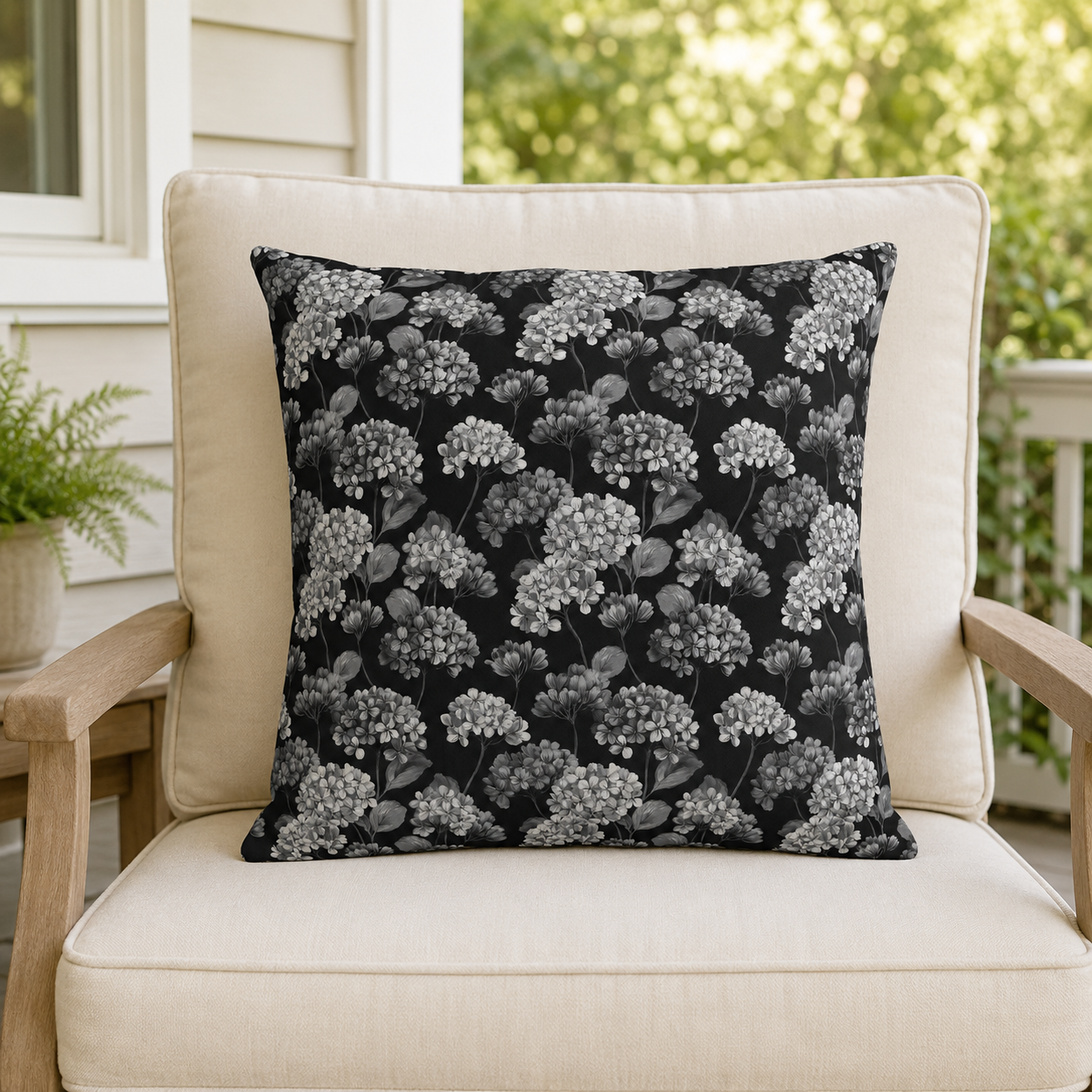 White and grey hydrangeas on black outdoor pillow