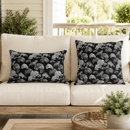 White and grey hydrangeas on black outdoor pillow