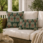 Cream foliage sprays tied with clay red bows on a deep forest green background