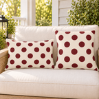 Merlot polka dot outdoor pillow and outdoor lumbar pillow styled together as a set