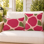 Pink and olive pebble outdoor pillow and outdoor lumbar pillow styled together as a set