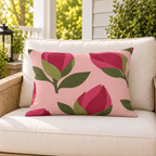Pink flower bud floral outdoor lumbar pillow styled on patio furniture
