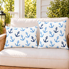Light blue anchor outdoor pillow and outdoor lumbar pillow styled together as a set on a porch loveseat