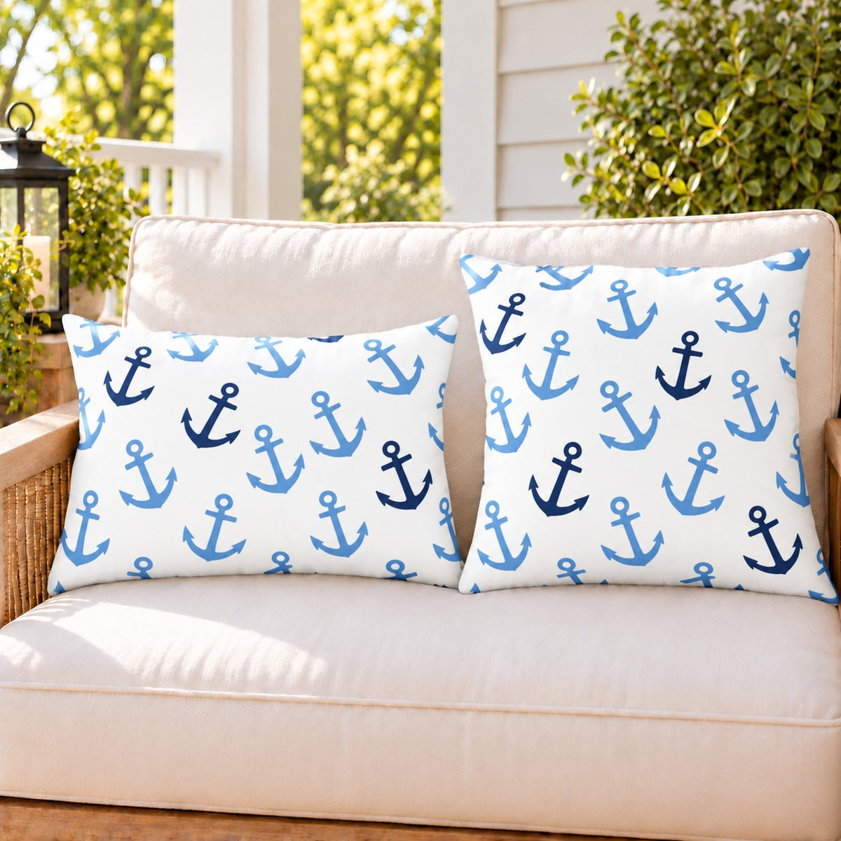 Light blue anchor outdoor pillow and outdoor lumbar pillow styled together as a set on a porch loveseat