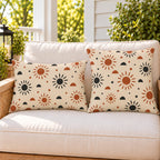 Boho sunburst outdoor pillow and outdoor lumbar pillow styled together as a set on a porch loveseat
