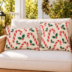 Red candy cane Christmas outdoor pillow and outdoor lumbar pillow styled together as a set on a porch loveseat