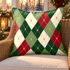 Green and red argyle outdoor pillow on a rattan chair on a snowy Christmas porch