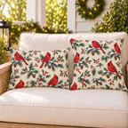 Cream Christmas cardinal outdoor pillow and outdoor lumbar pillow styled together as a set on a porch loveseat for Christmas