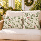 Green Christmas mistletoe outdoor pillow and outdoor lumbar pillow styled together as a set on a porch loveseat for Christmas