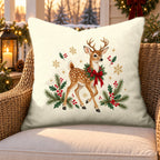 Cream Christmas reindeer outdoor pillow on a rattan chair on a snowy Christmas porch