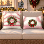 Red pinstripe Christmas wreath outdoor pillow and outdoor lumbar pillow styled together as a set on a wicker loveseat for Christmas