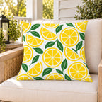 Yellow lemon citrus outdoor pillow on a rattan chair on a sunny summer porch