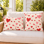 Cupid Arrow Red outdoor pillow and outdoor lumbar pillow styled together as a set on a porch loveseat