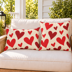 Heart Toss Red outdoor pillow and outdoor lumbar pillow styled together as a set on a porch loveseat