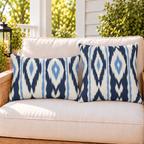 Navy and white ikat stripe outdoor pillow and outdoor lumbar pillow styled together as a set on a porch loveseat