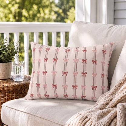 Pink and red ribbon bows on striped blush outdoor lumbar pillow