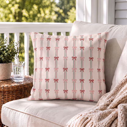 Pink and red ribbon bows on striped blush outdoor pillow