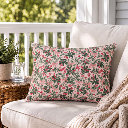 Holly, pine, red berries and pink bows on blush outdoor lumbar pillow