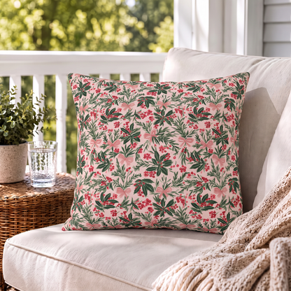 Holly, pine, red berries and pink bows on blush outdoor pillow