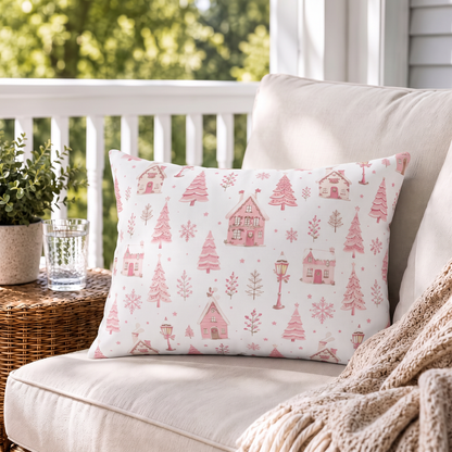 Pink gingerbread houses, trees and lampposts on white outdoor lumbar pillow