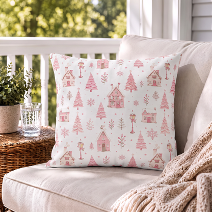 Pink gingerbread houses, trees and lampposts on white outdoor pillow