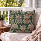 Forest green outdoor pillow with cream garland sprays and clay bows, second view