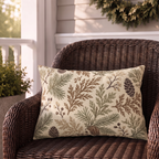 Cream outdoor lumbar pillow with sage and brown evergreen branches and pinecones, second view
